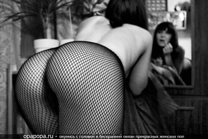 Черно-белое фото: темноволосая Фекла у зеркала без трусов в колготках